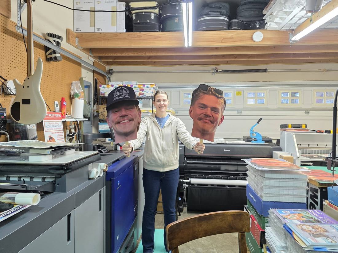 The Happy Valley Printing family team in the shop with production printers